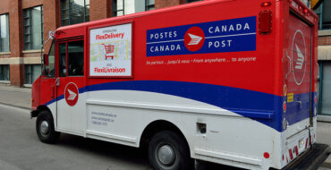 A Canada Post mail truck on a city street