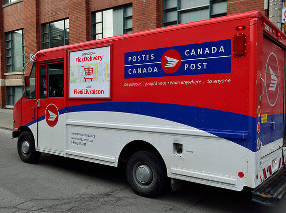 A Canada Post mail truck on a city street