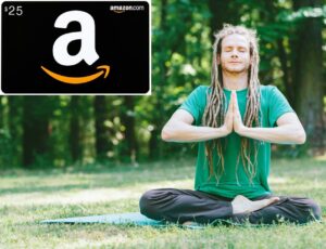 A young white man with long dreadlocks in a green t-shirt and black sweatpants sits crosslegged on a mat in a meadow in front of a forested area, meditating with his eyes closed and his hands pressed together in front of his chest in a prayer pose. In the top left corner of the image, there's an insert of a $25 Amazon gift card.