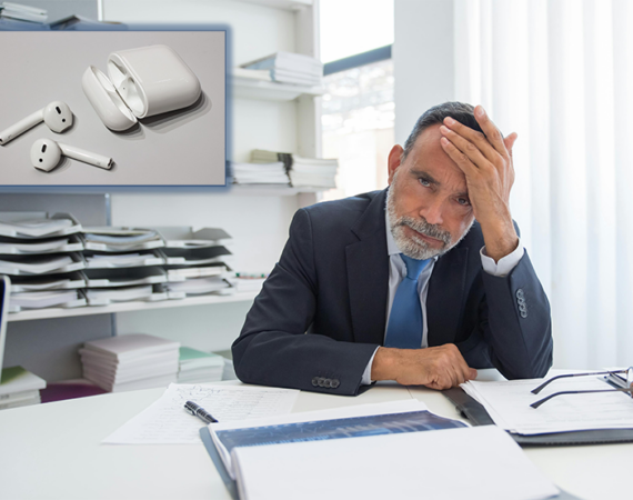 a man in his fifties or sixties is holding his head in anguish. in the upper left corner, an insert photo of a pair of airpods