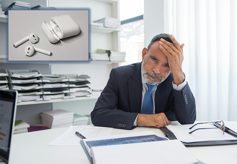 a man in his fifties or sixties is holding his head in anguish. in the upper left corner, an insert photo of a pair of airpods