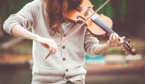 a woman playing a violin, her face isn't visible