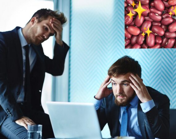 two young men in business suits looking at a computer and rubbing their foreheads in dismay. Inset in the upper right corner is a photo of red beans with sparkles.