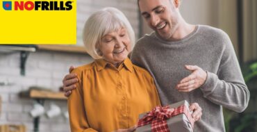 A young man is happily giving his mother a nicely wrapped gift. There's a yellow "No Frills" logo in the upper left corner.