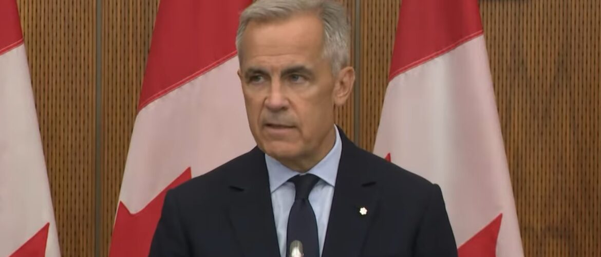Mark Carney giving a speech in front of Canadian flags